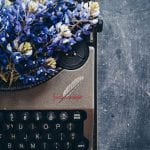 typewriter with purple flowers